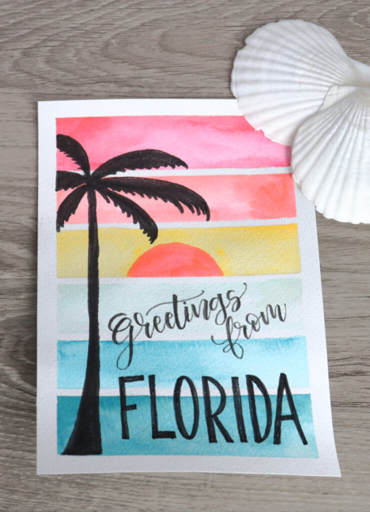 Image contains a watercolor sunset postcard with a palm tree silhouette and the words “Greetings from Florida.” It is intended for saving to Pinterest.